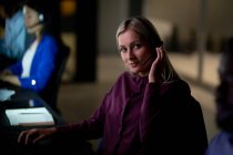 Portrait of caucasian businesswoman working at night wearing headset. working late in business at a modern office. — Stock Photo