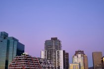 Modern high rise buildings in built up business district of modern city with dusk sky. modern architectural cityscape. — Stock Photo