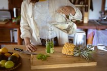 Woman preparing healthy drink in kitchen. healthy lifestyle, enjoying leisure time at home. — Stock Photo