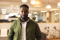 Portrait of smiling african american male creative looking to camera. working in creative business at a modern office. — Stock Photo