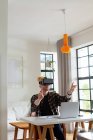 Happy albino african american man with dreadlocks working from home and using vr headsets. remote working using technology at home. — Stock Photo