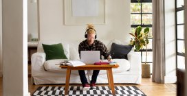 Albino african american man with dreadlocks working from home and making video call on the laptop. remote working using technology at home. — Stock Photo
