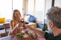 Happy caucasian mature couple having a romantic dinner at home. enjoying leisure time at home. — Stock Photo