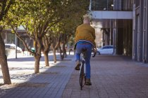 Albino homem americano africano com dreadlocks andar de bicicleta. em movimento, fora e em torno da cidade. — Fotografia de Stock