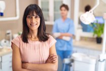 Portrait of smiling caucasian female patient looking at camera at modern dental clinic. healthcare and dentistry business. — Stock Photo