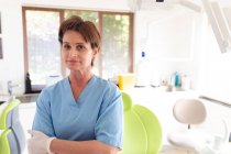 Portrait of smiling caucasian female dental nurse looking at camera at modern dental clinic. healthcare and dentistry business. — Stock Photo
