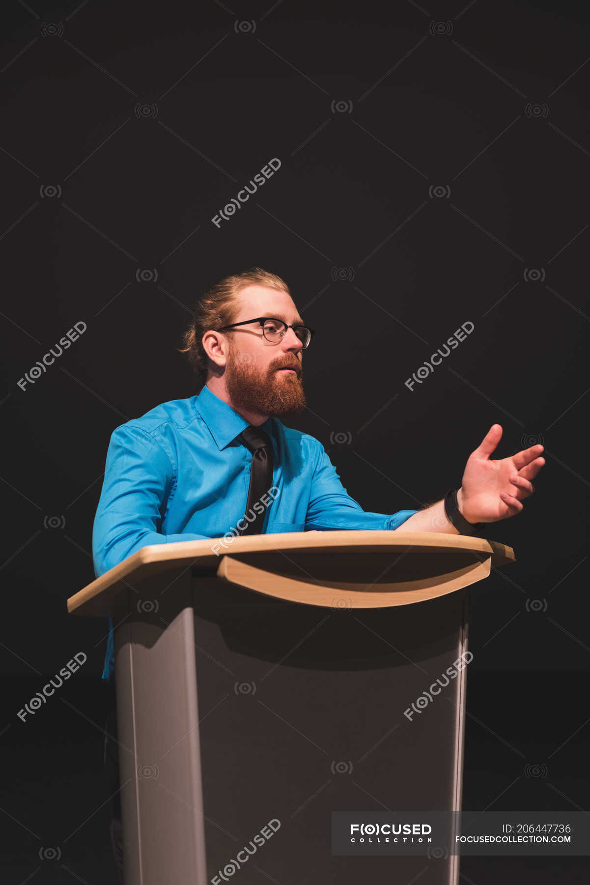 man-practicing-his-speech-on-stage-at-theater-male-podium-stock