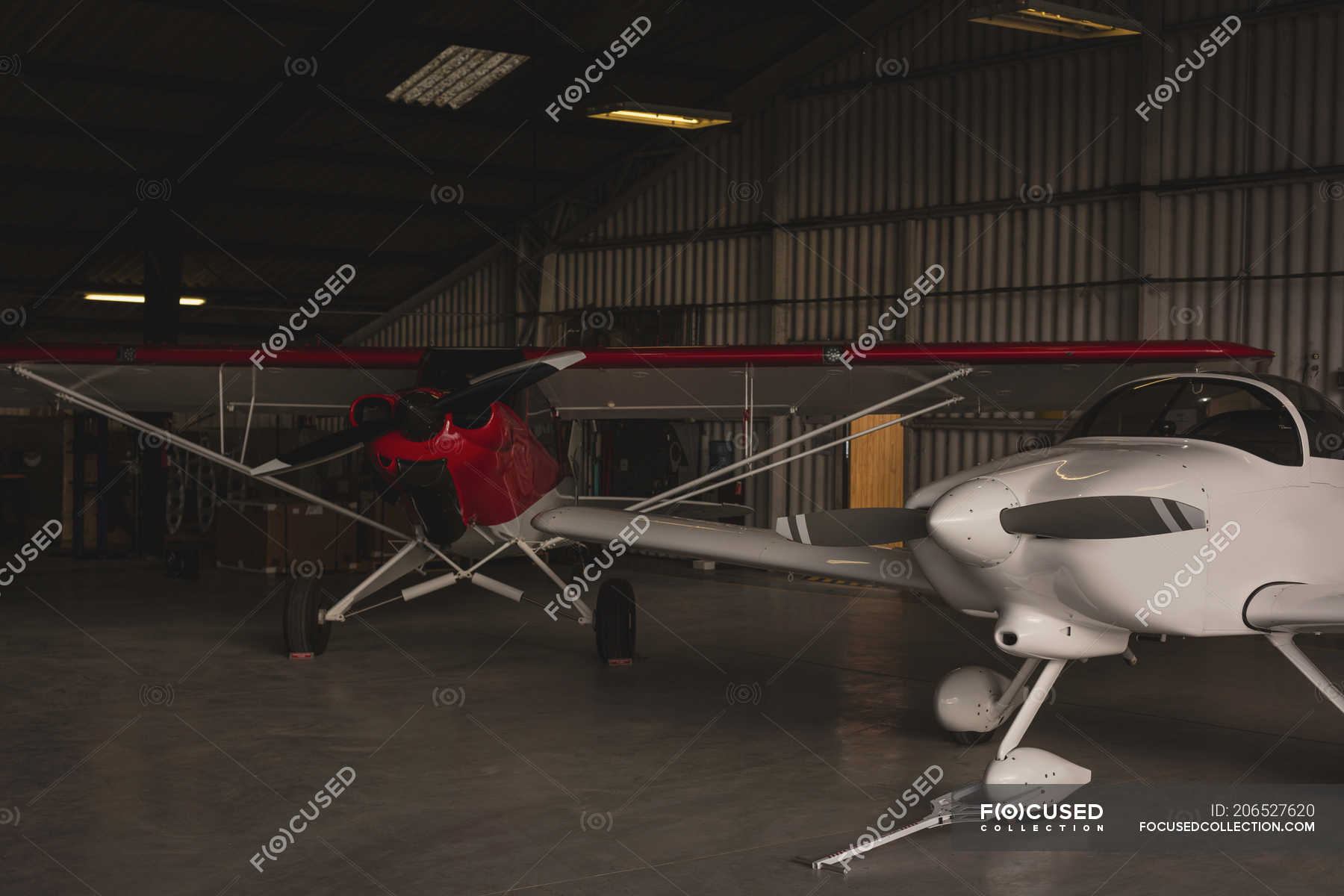 Two manufactured aircrafts parked in aerospace hangar — flights, inside