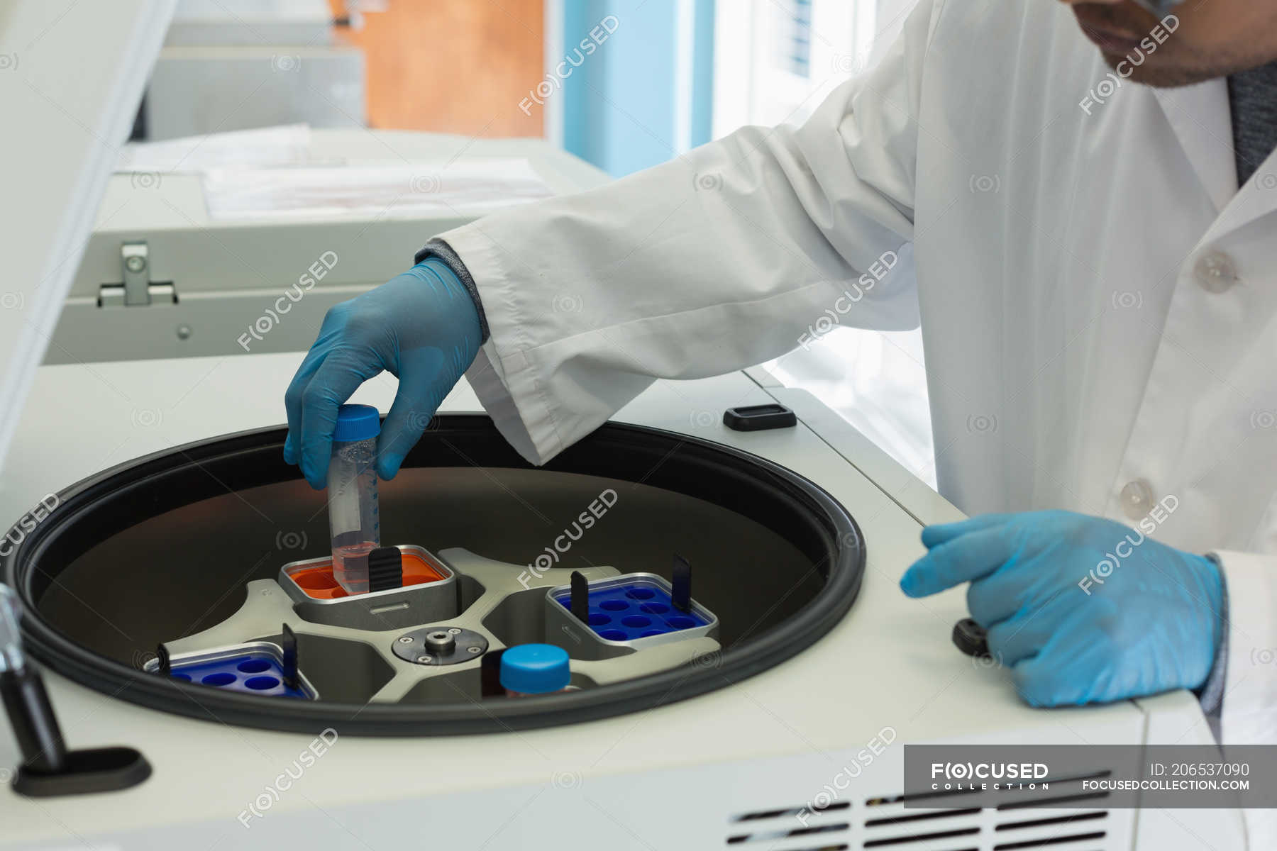 Scientist using a machine for experiment in lab — pharmaceutical ...