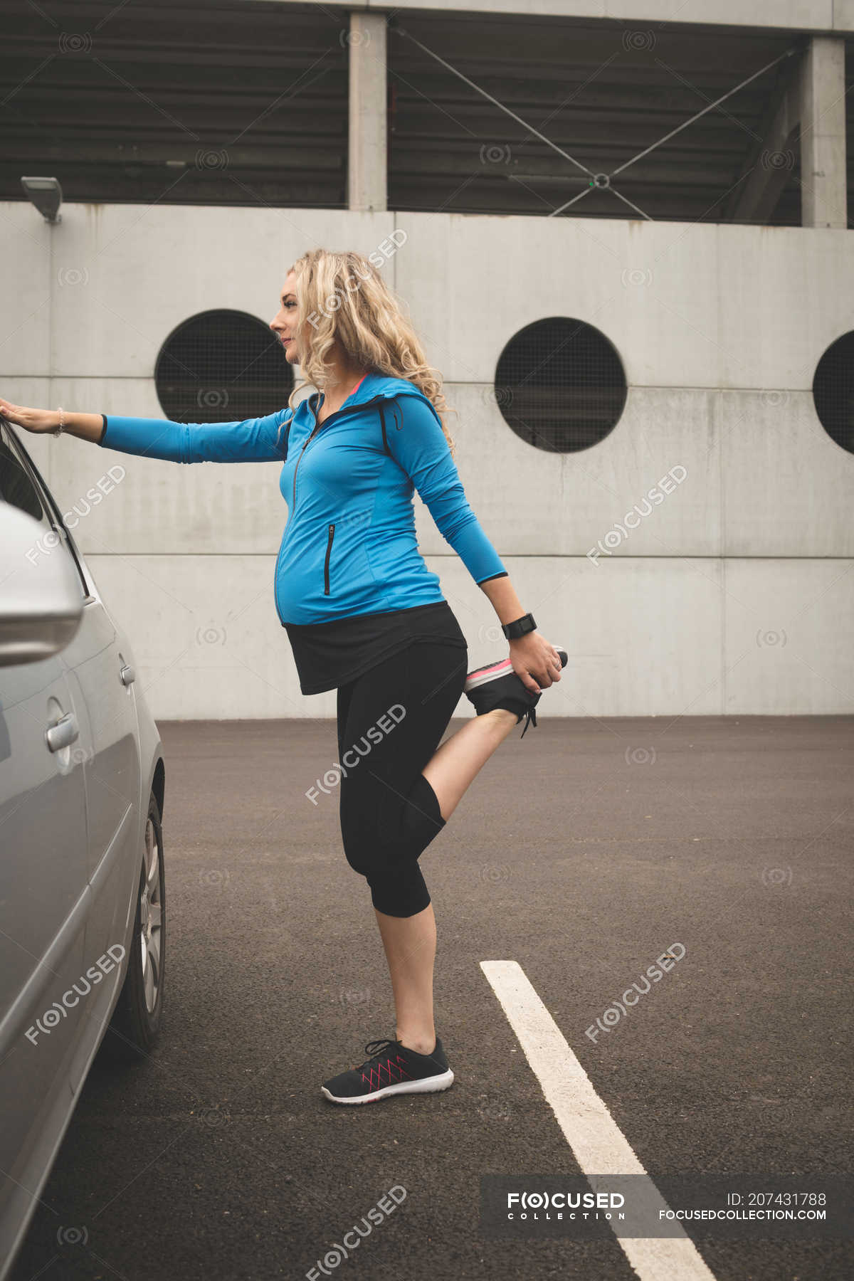 Pregnant Woman Exercising On A Car At Parking Area Relaxation Fitness Stock Photo