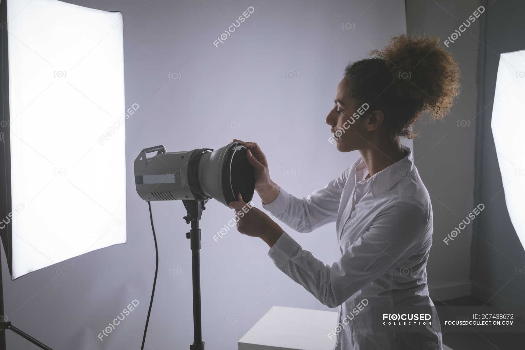 Female Photographer Adjusting Strobe Lights In Photo Studio Business Reflector Stock Photo 207438672