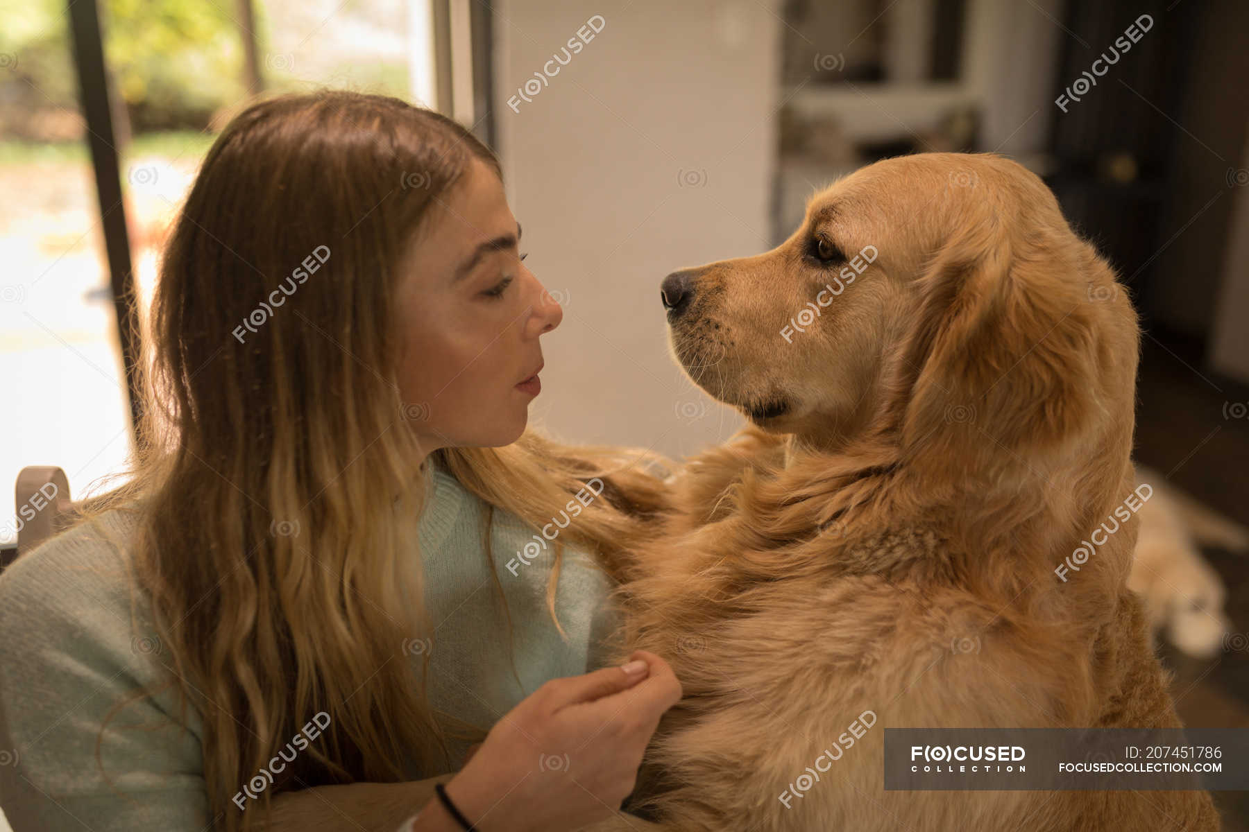 Teenage Girl Playing With Her Dog At Home Blonde Covid19 Stock 