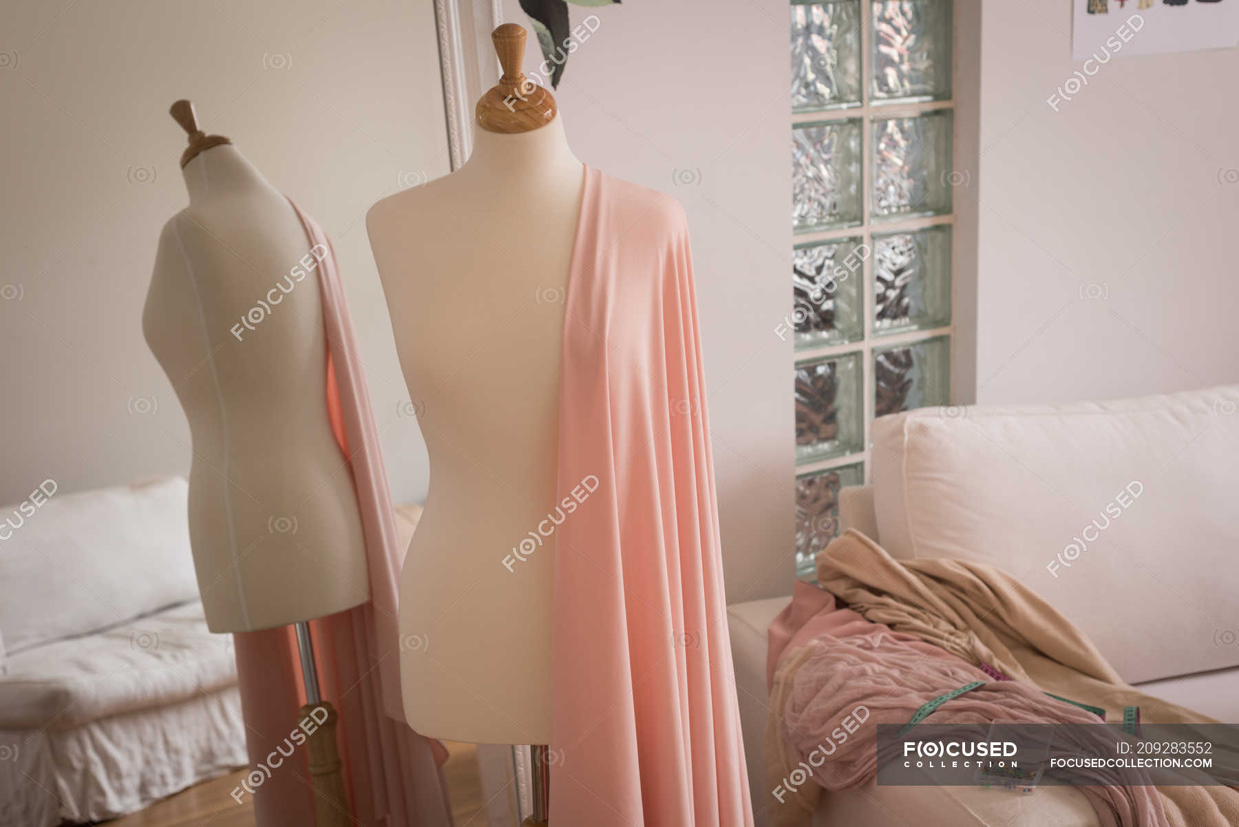Mannequin with fabric in front of mirror in design studio