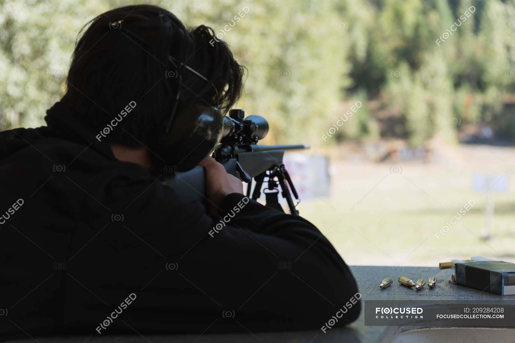 Man Aiming Sniper Rifle At Target In Shooting Range On A Sunny Day Determination Practicing Stock Photo