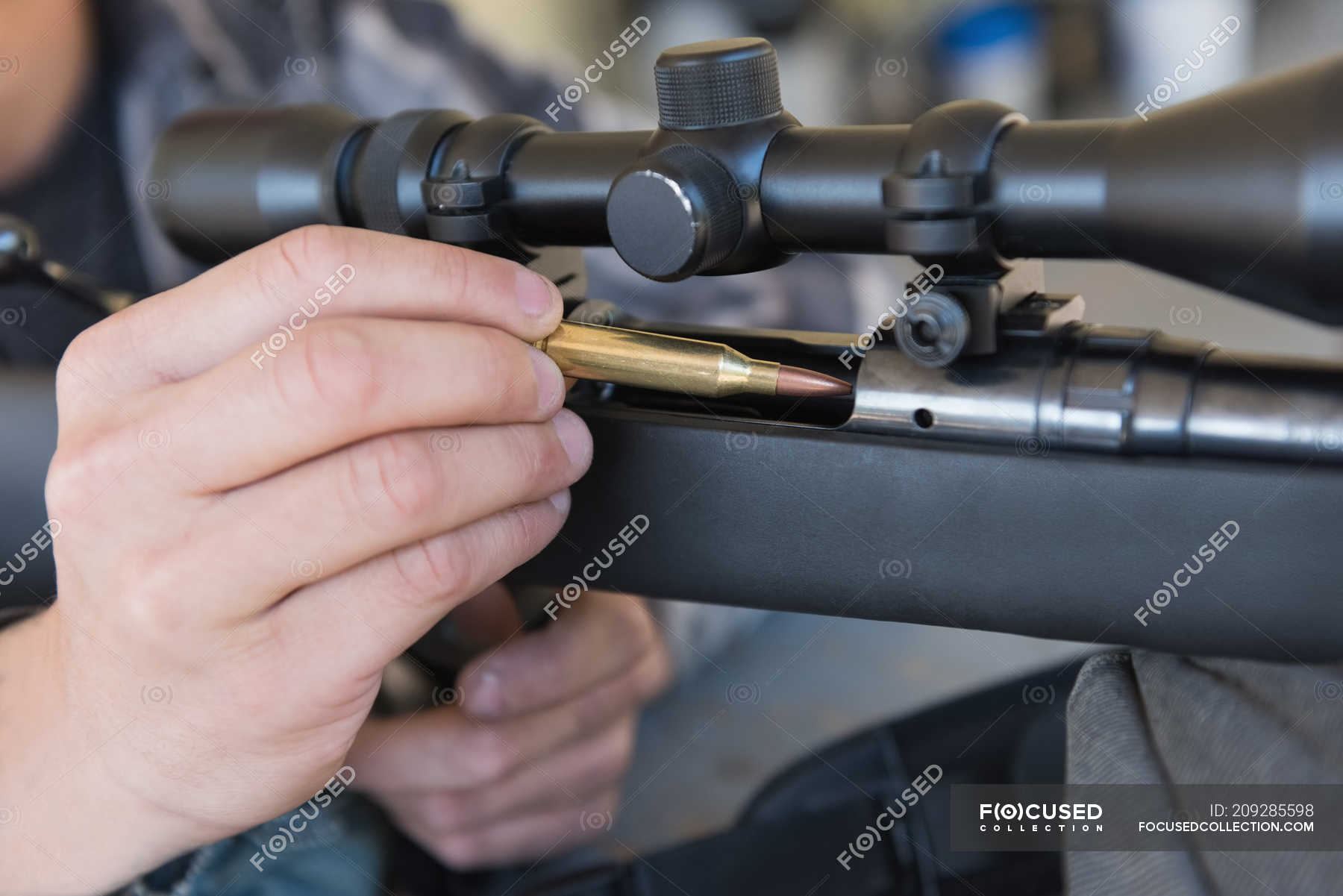 Close up Of Man Loading Bullet Into Sniper Rifle Training Partial 