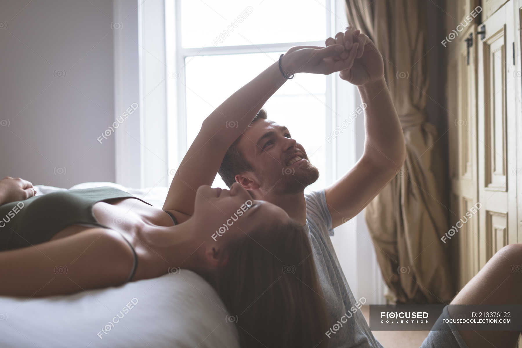 Couple Having Fun In Bedroom At Home Casual Clothing