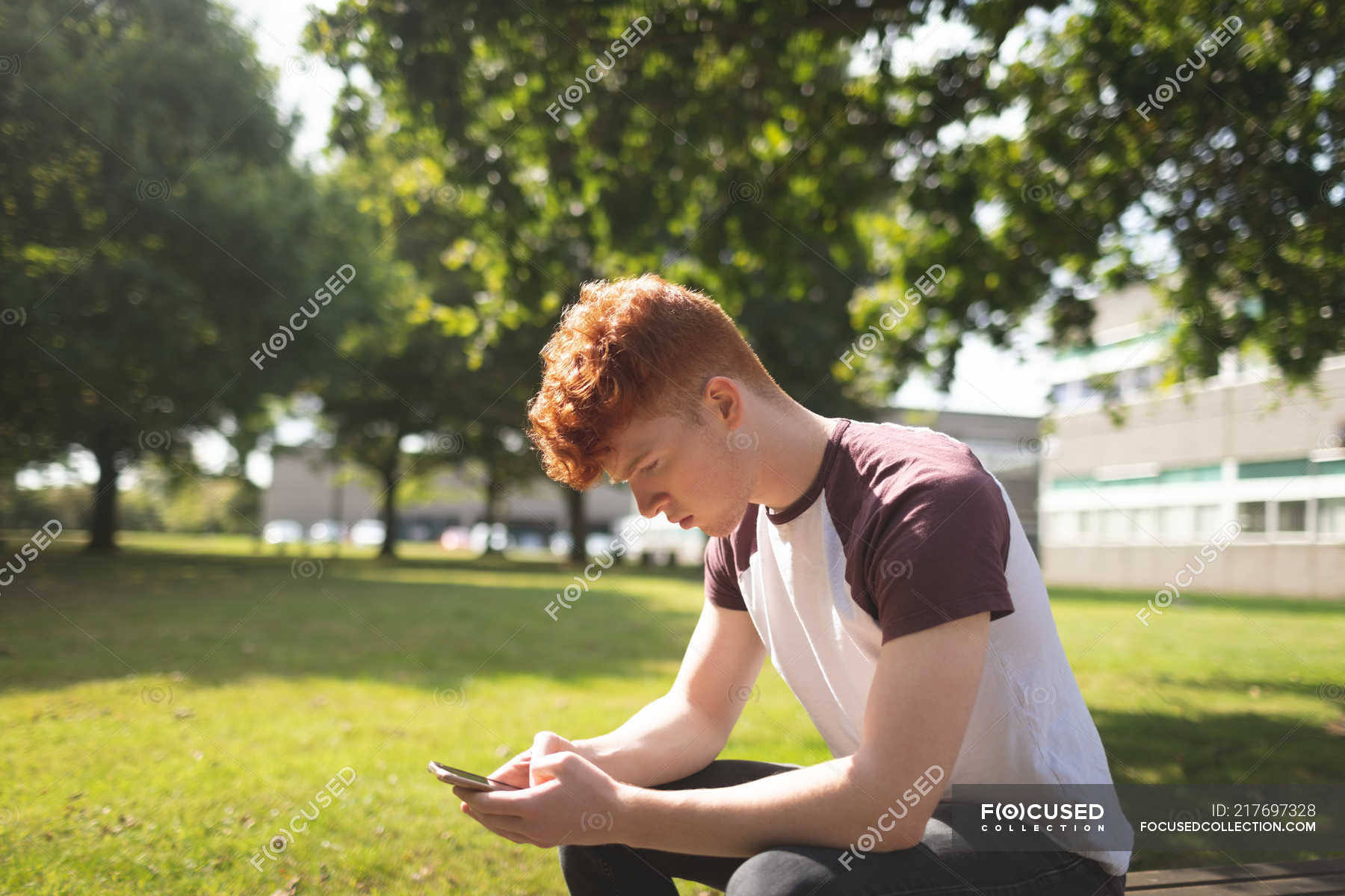 College student using mobile phone in campus — connection, youth Stock Photo 217697328