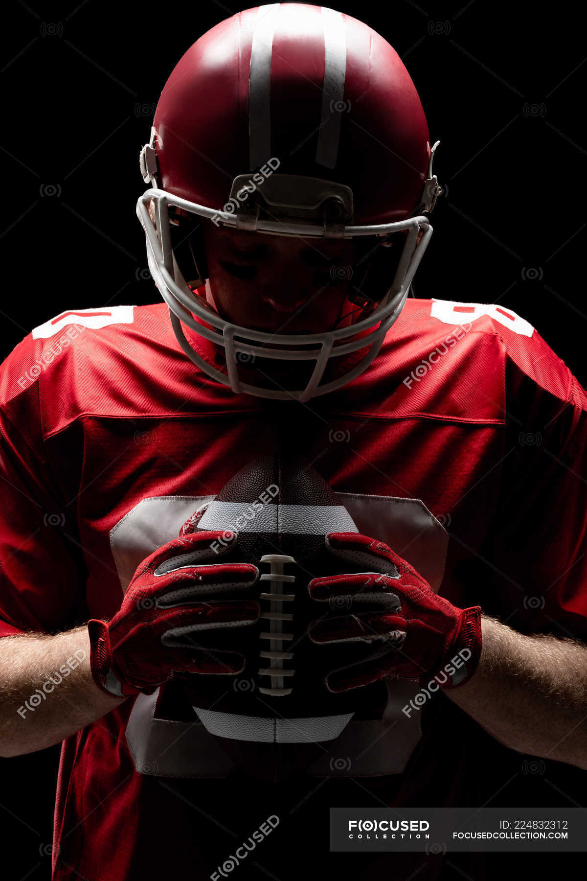 Close Up Of American Football Player With Helmet Looking At Rugby Ball One Person Profession Stock Photo