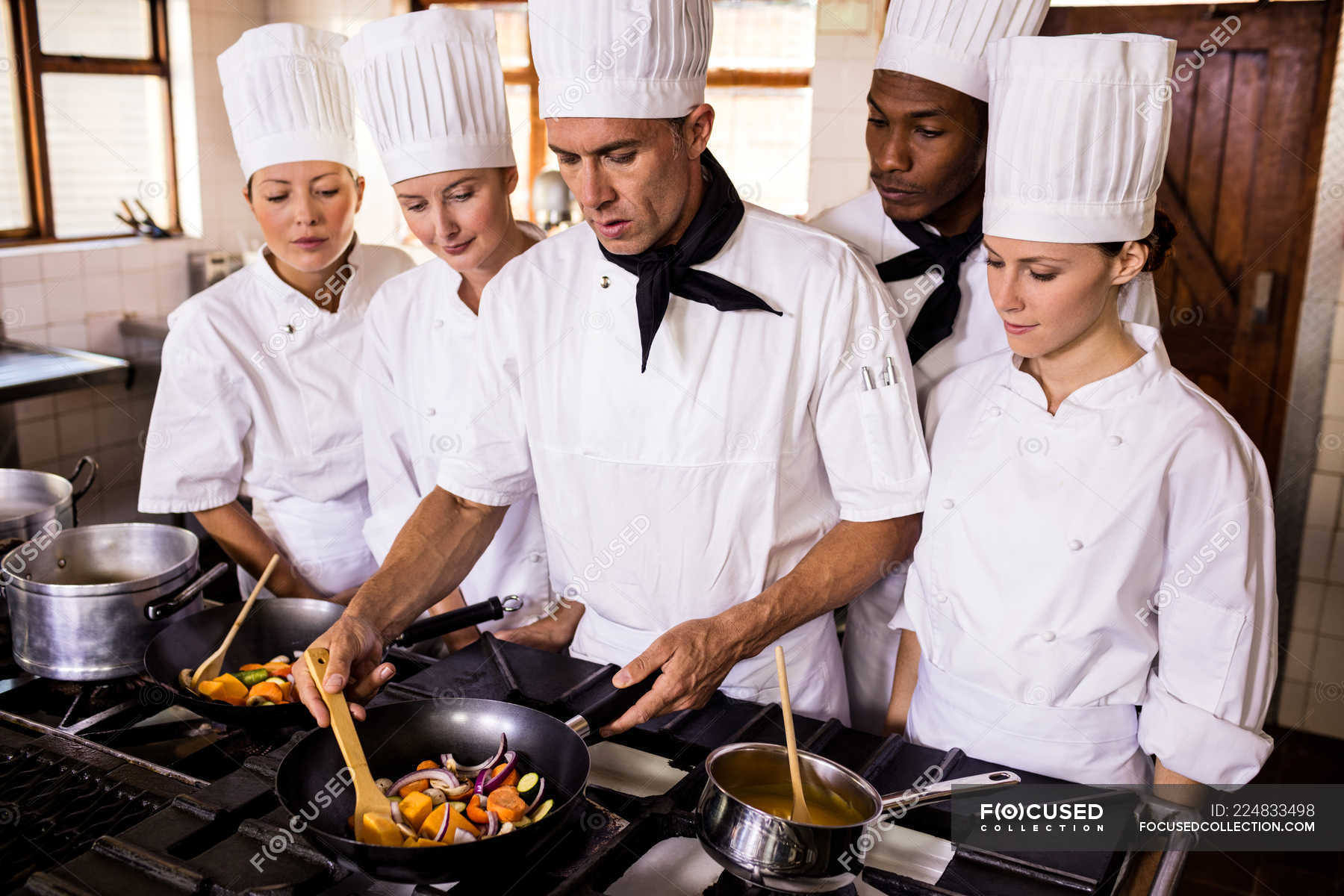 Head Chef Teaching His Team To Prepare A Food In Kitchen 20s 40 44 