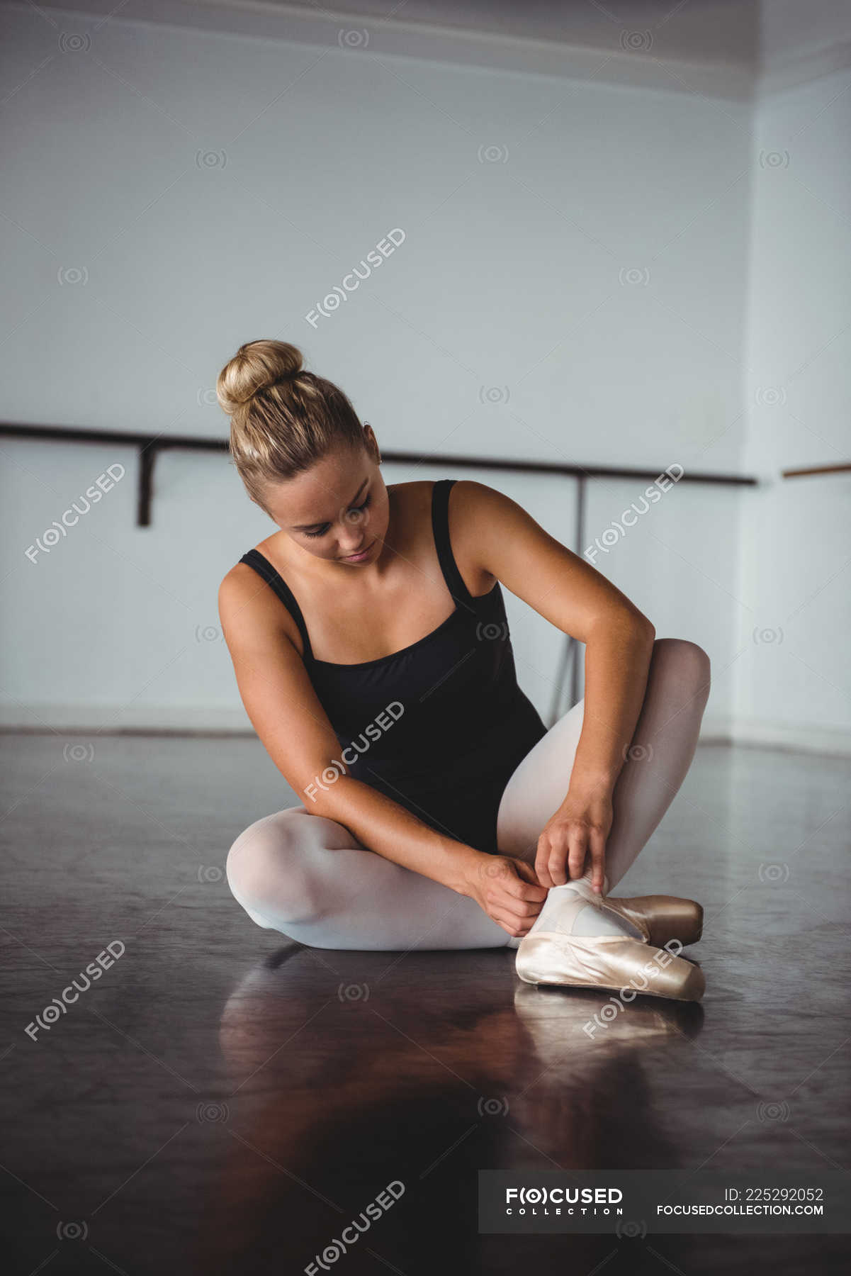 Problem Pioner offset Ballerina adjusting stockings while sitting in ballet studio — classical,  lifestyle - Stock Photo | #225292052