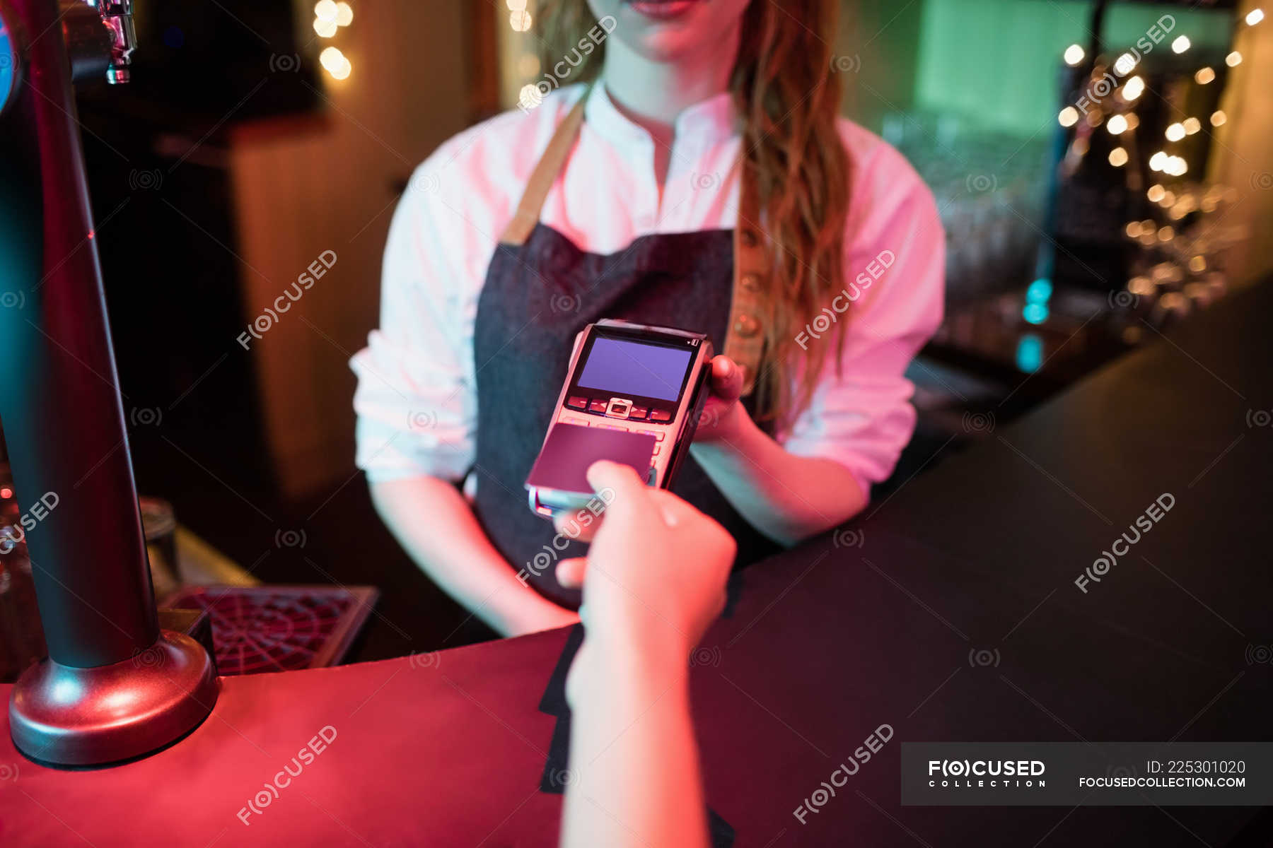 Customer Making Payment Through Credit Card At Counter In Bar Hotel 