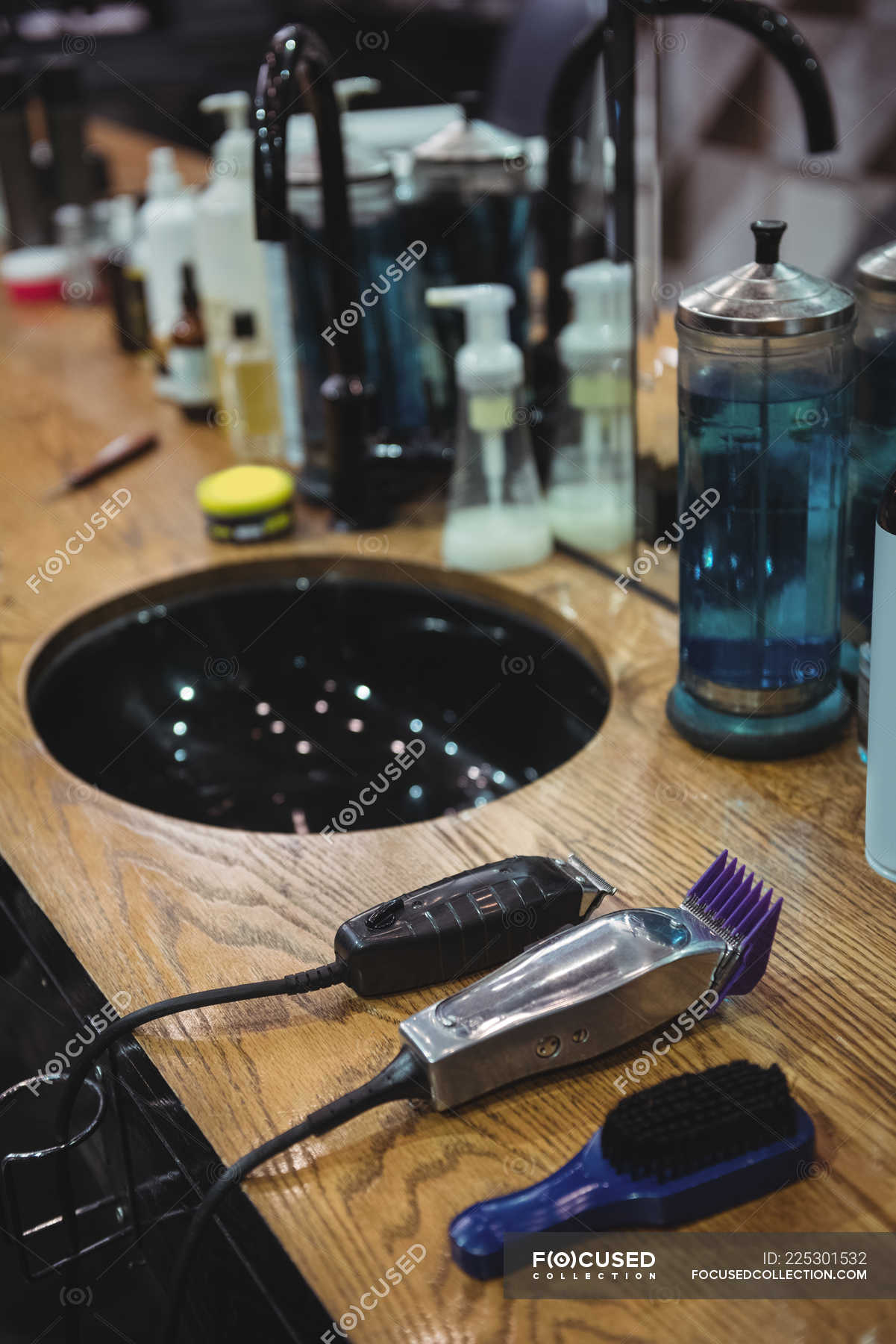 Various beauty products and barber tools on dressing table in ...