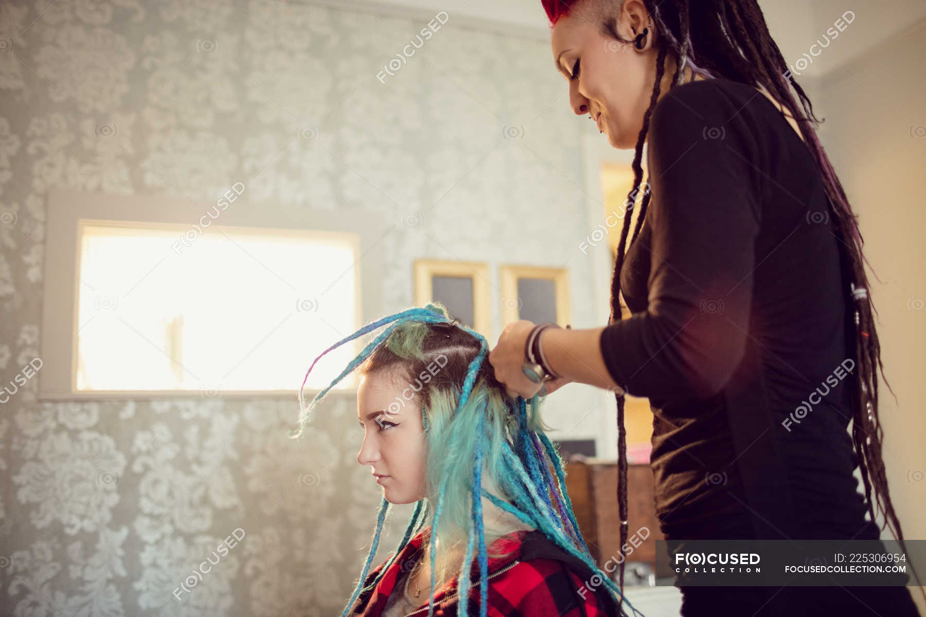 Beautician styling clients hair in dreadlocks shop — profession, braid -  Stock Photo | #225306954