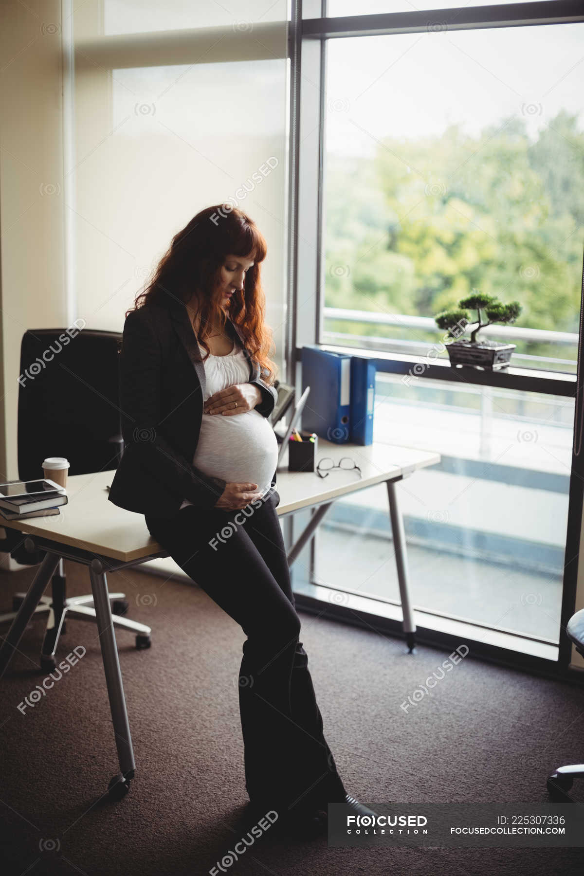 Pregnant Woman Sitting Office Chair Touching Belly Stock Photo by  ©HayDmitriy 275243902