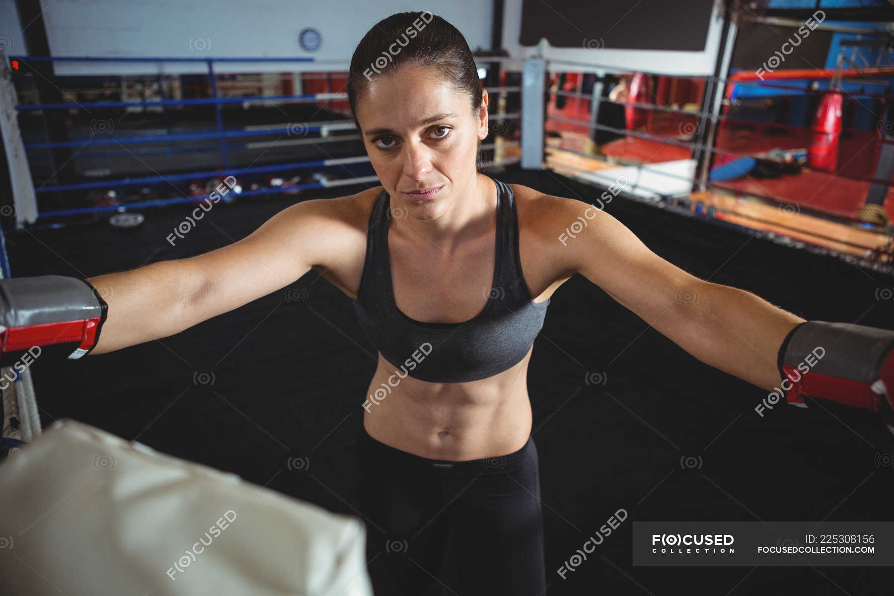 Portrait Of Confident Female Boxer Standing In Boxing Ring Stock Photo