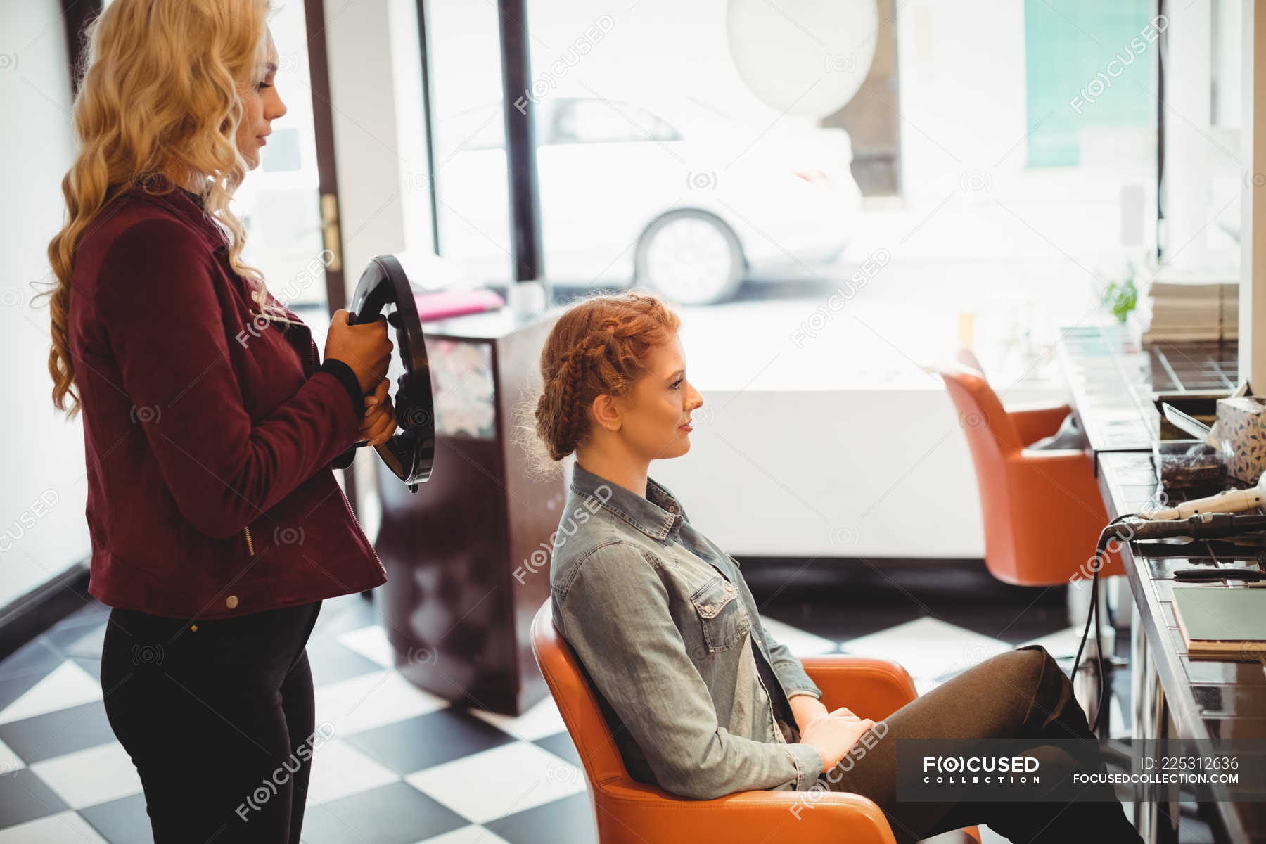 Female hairdresser styling clients hair in saloon — skill, Expertise