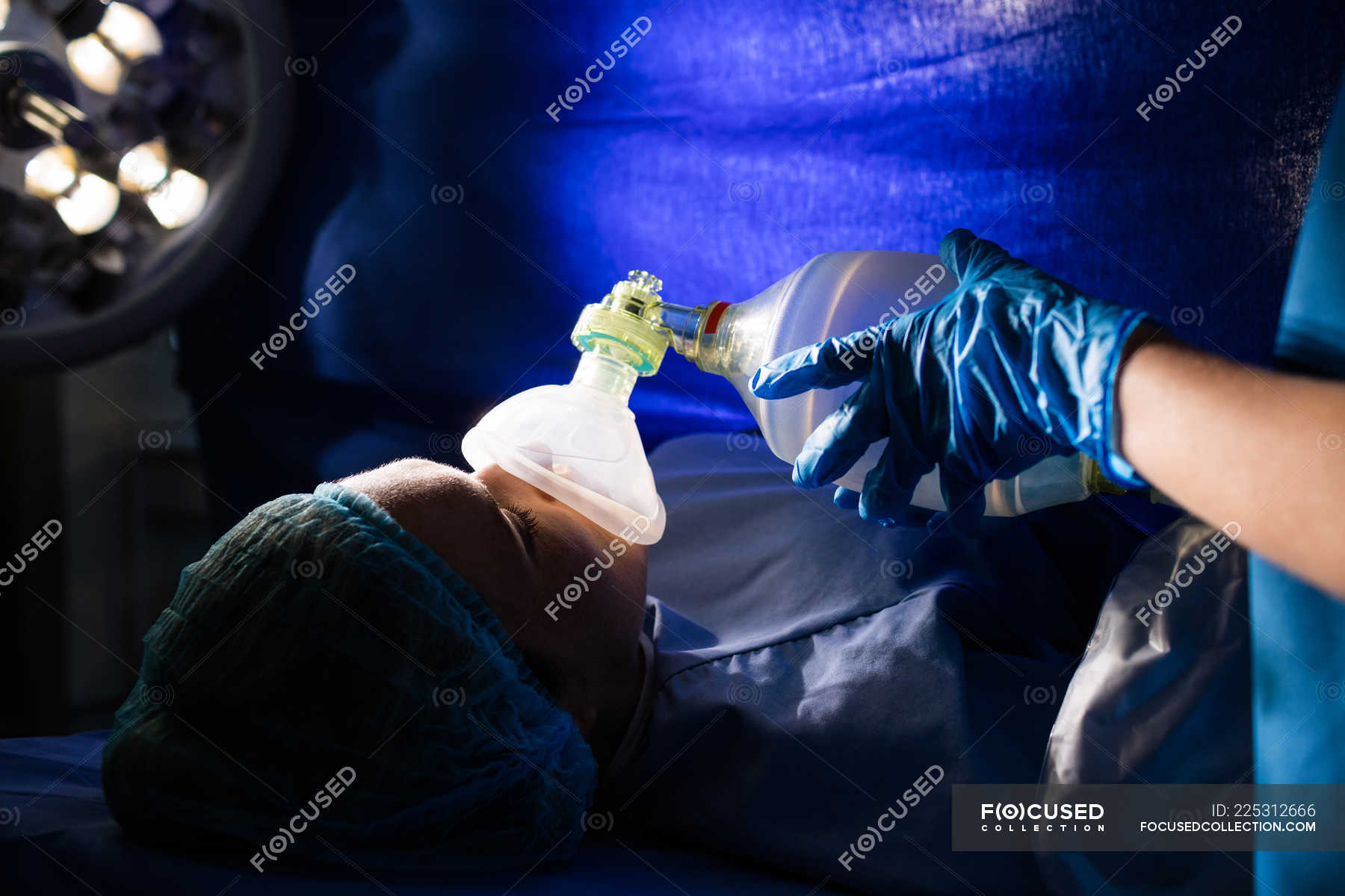 Hand of a doctor giving oxygen to a pregnant woman in operating room — holding, responsibility