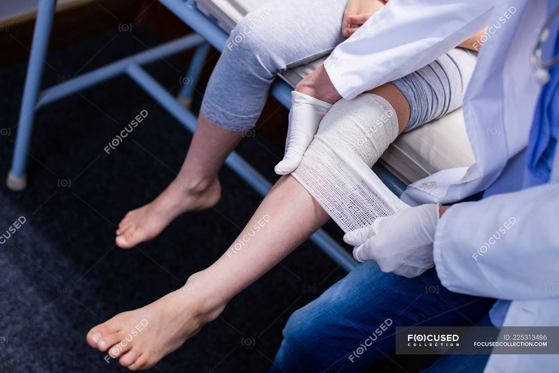 doctor-putting-bandage-on-injured-leg-of-patient-in-hospital-fracture