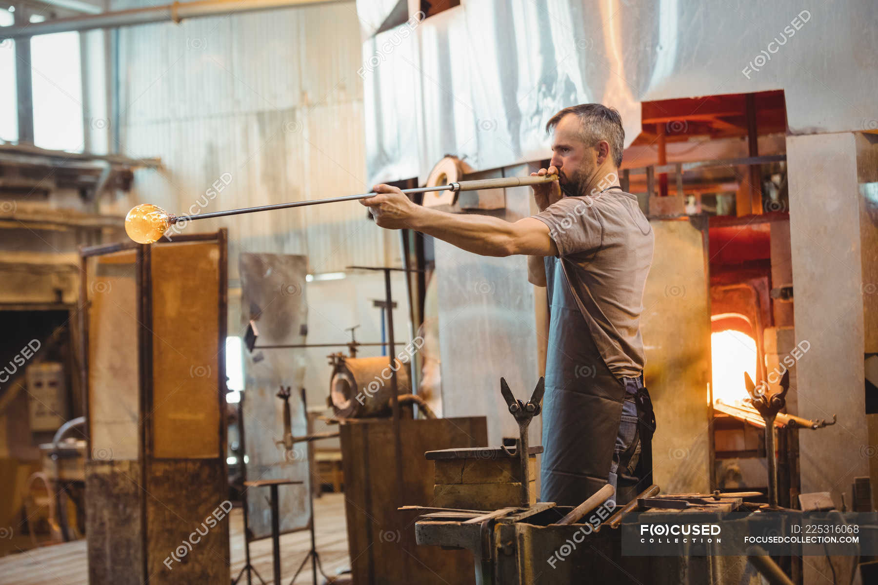 Glassblower Shaping A Glass On The Blowpipe At Glassblowing Factory — Part Of Profession