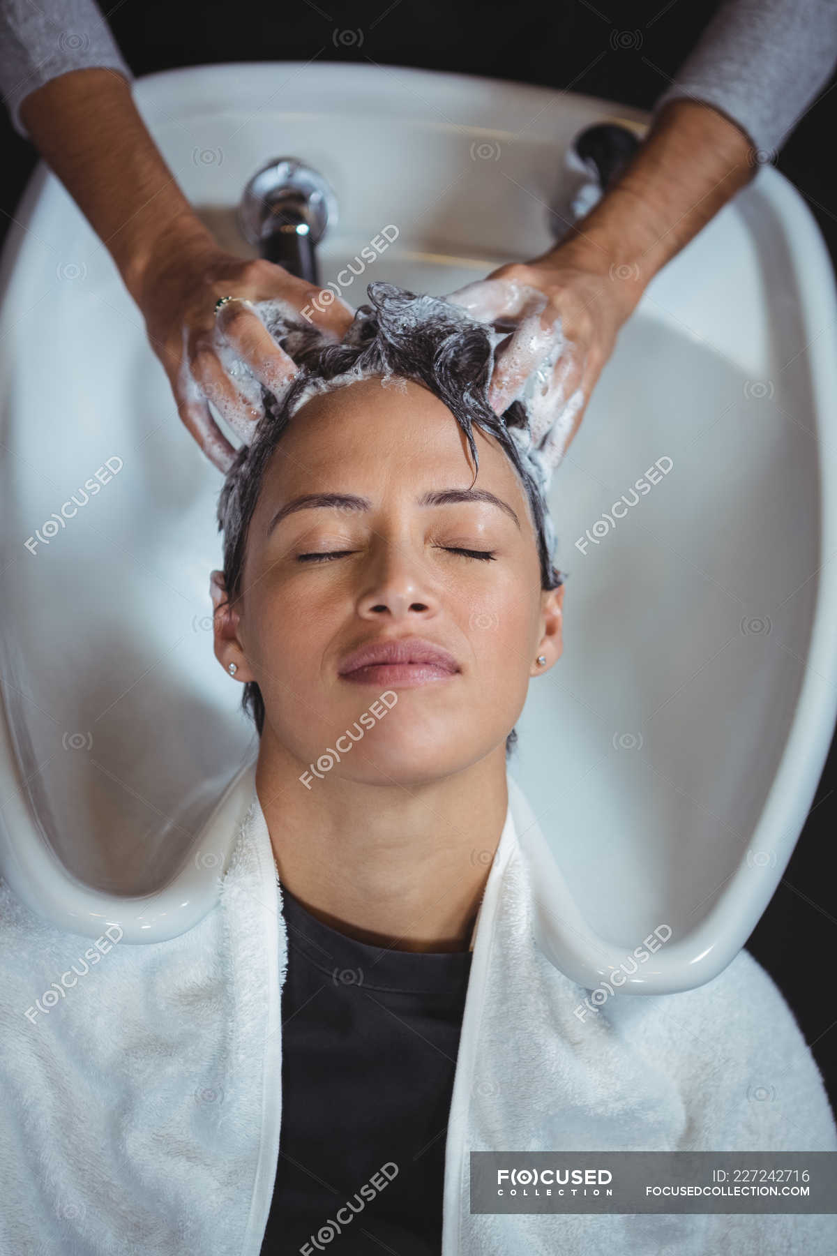 woman-getting-her-hair-wash-at-salon-profession-wash-basin-stock