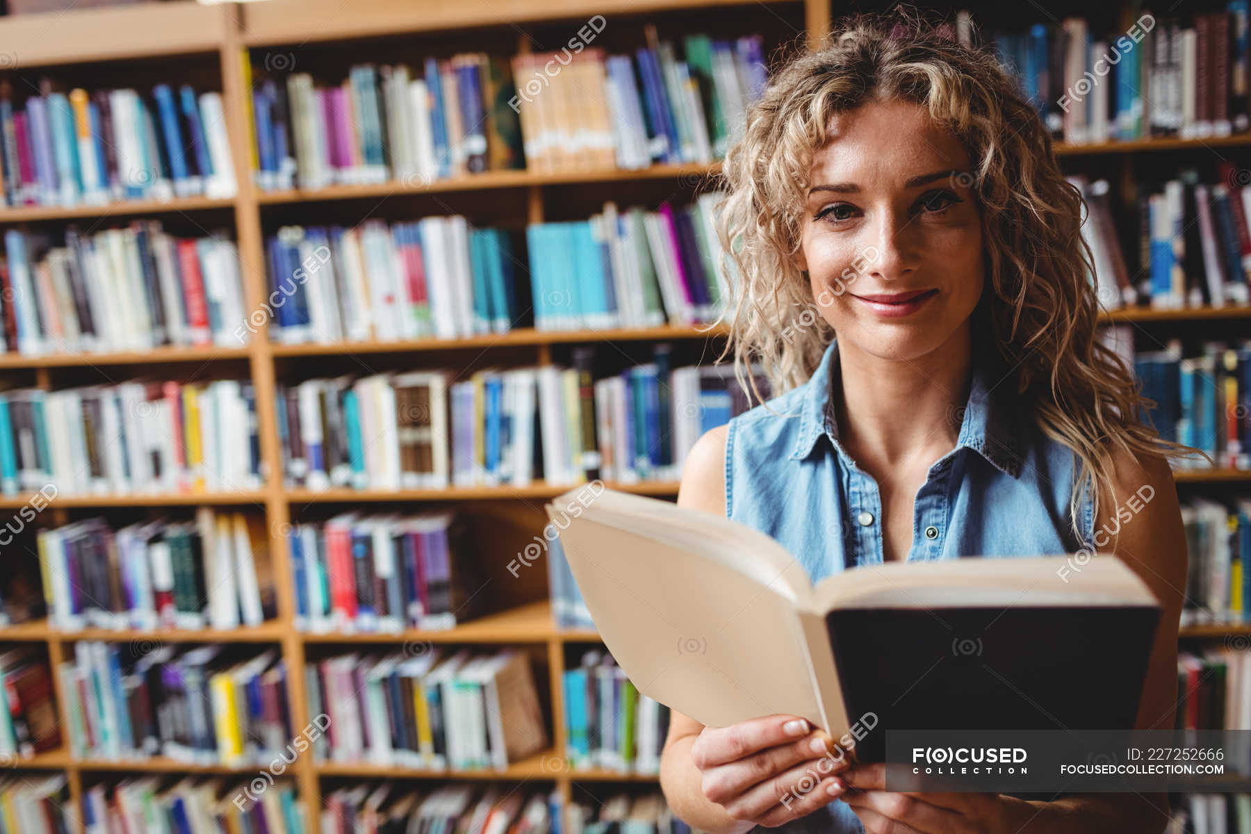 woman reading a book in library