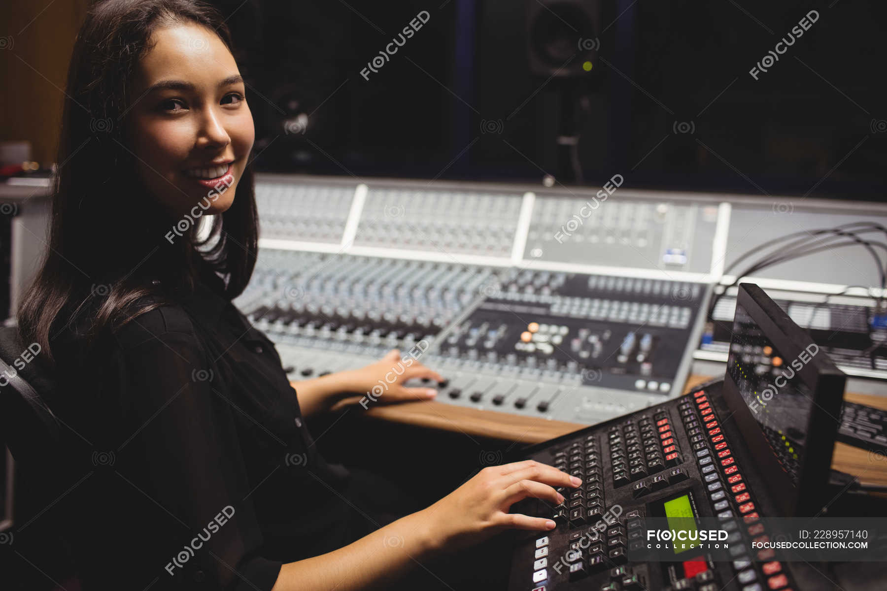 Female student using sound mixer keyboard in a studio — Mixed race, equipment Stock Photo