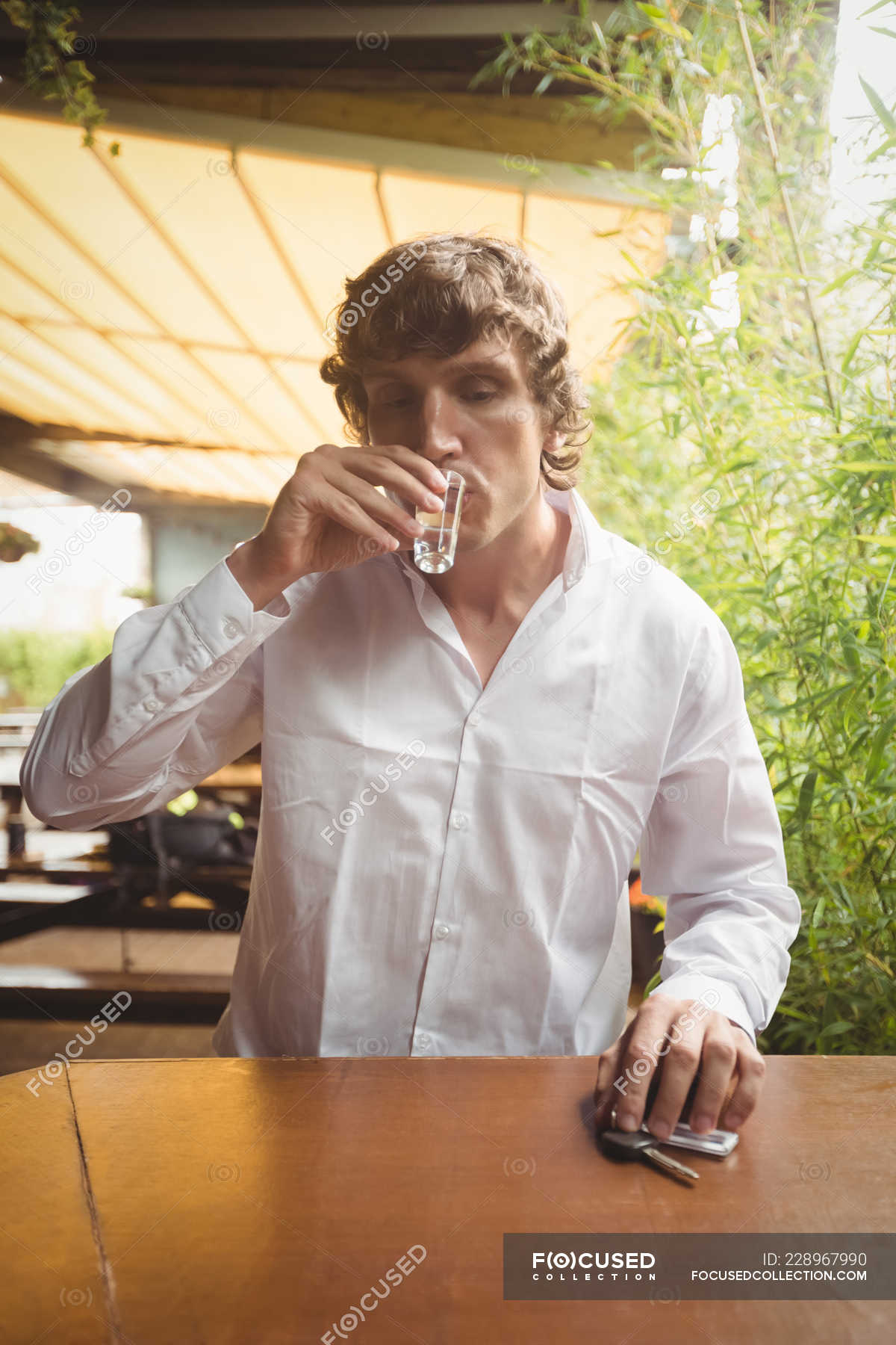 Man having tequila shot in bar counter at bar — shot glass, wooden ...