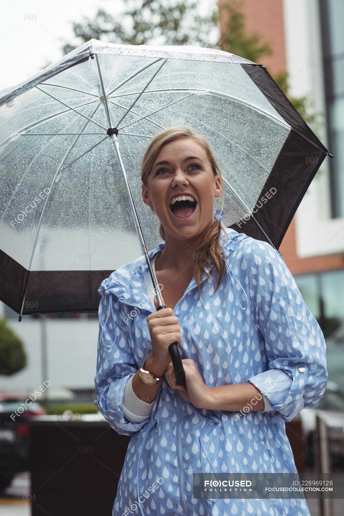 Laughing beautiful woman enjoying rain during rainy season — person ...