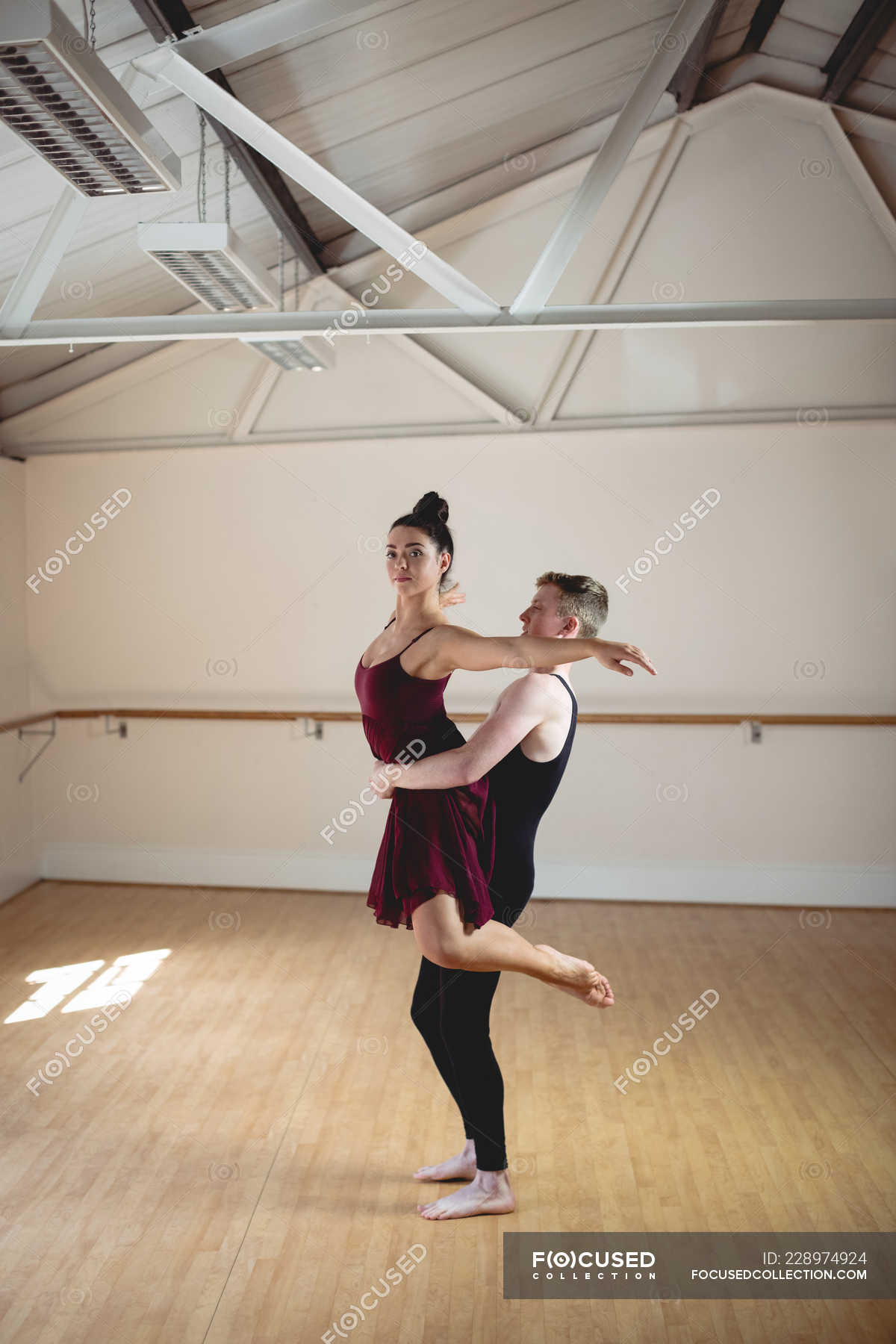 Ballet partners practicing together in modern studio — girl, ballerina ...