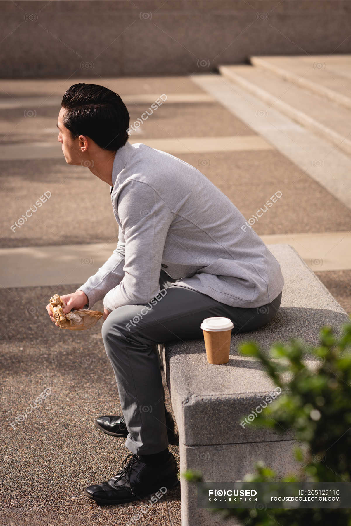 person sitting on bench side view