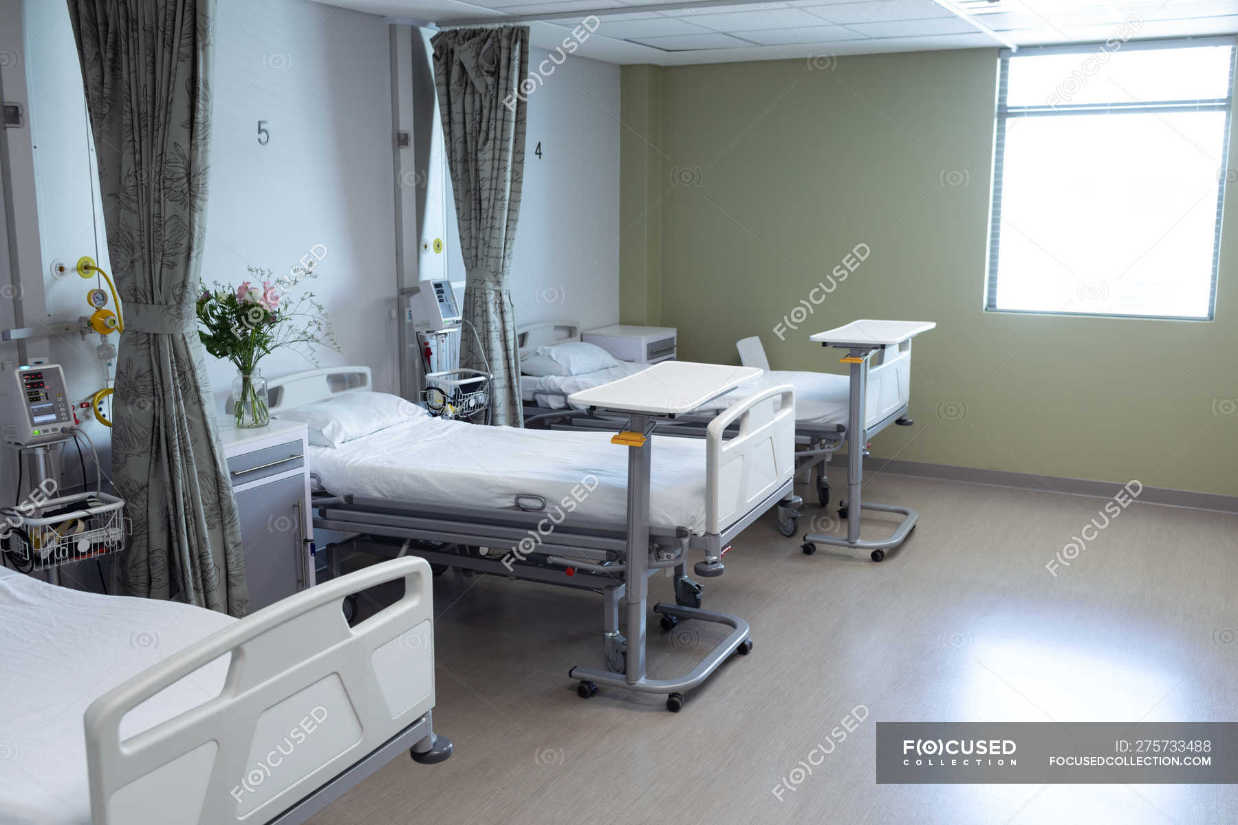 Modern hospital ward with empty beds, medical monitor ...