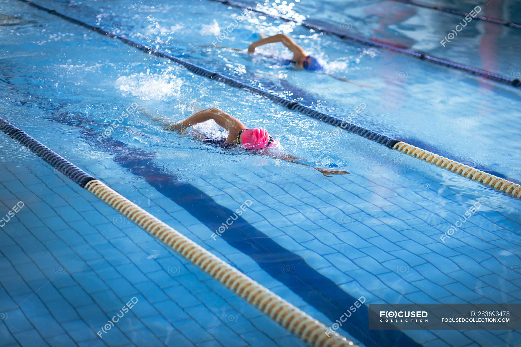 Side view of a young African-American and Caucasian women doing ...