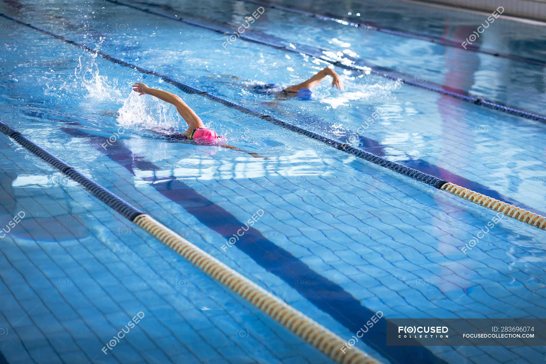 Side view of a young African-American and Caucasian women doing ...