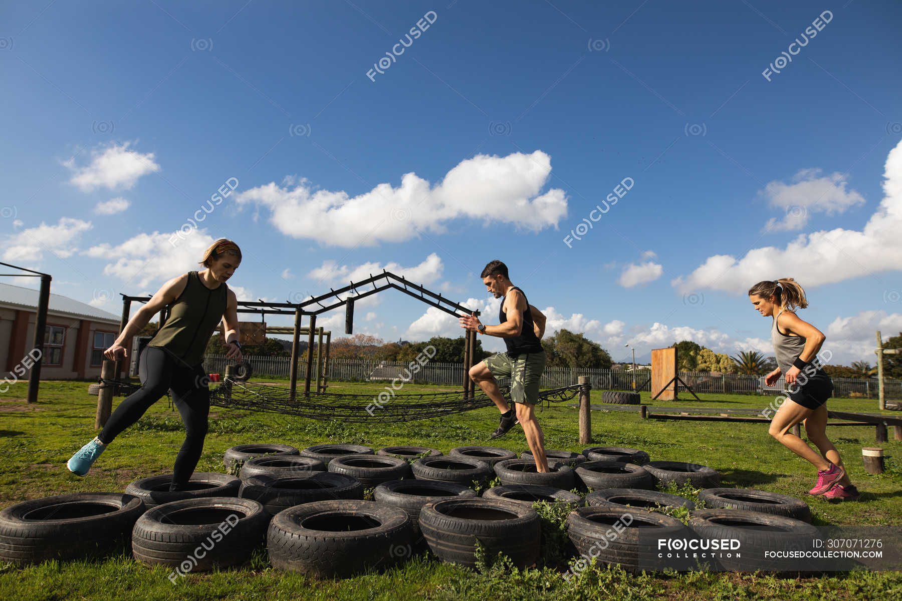 Side view of two young Caucasian women and a young Caucasian man