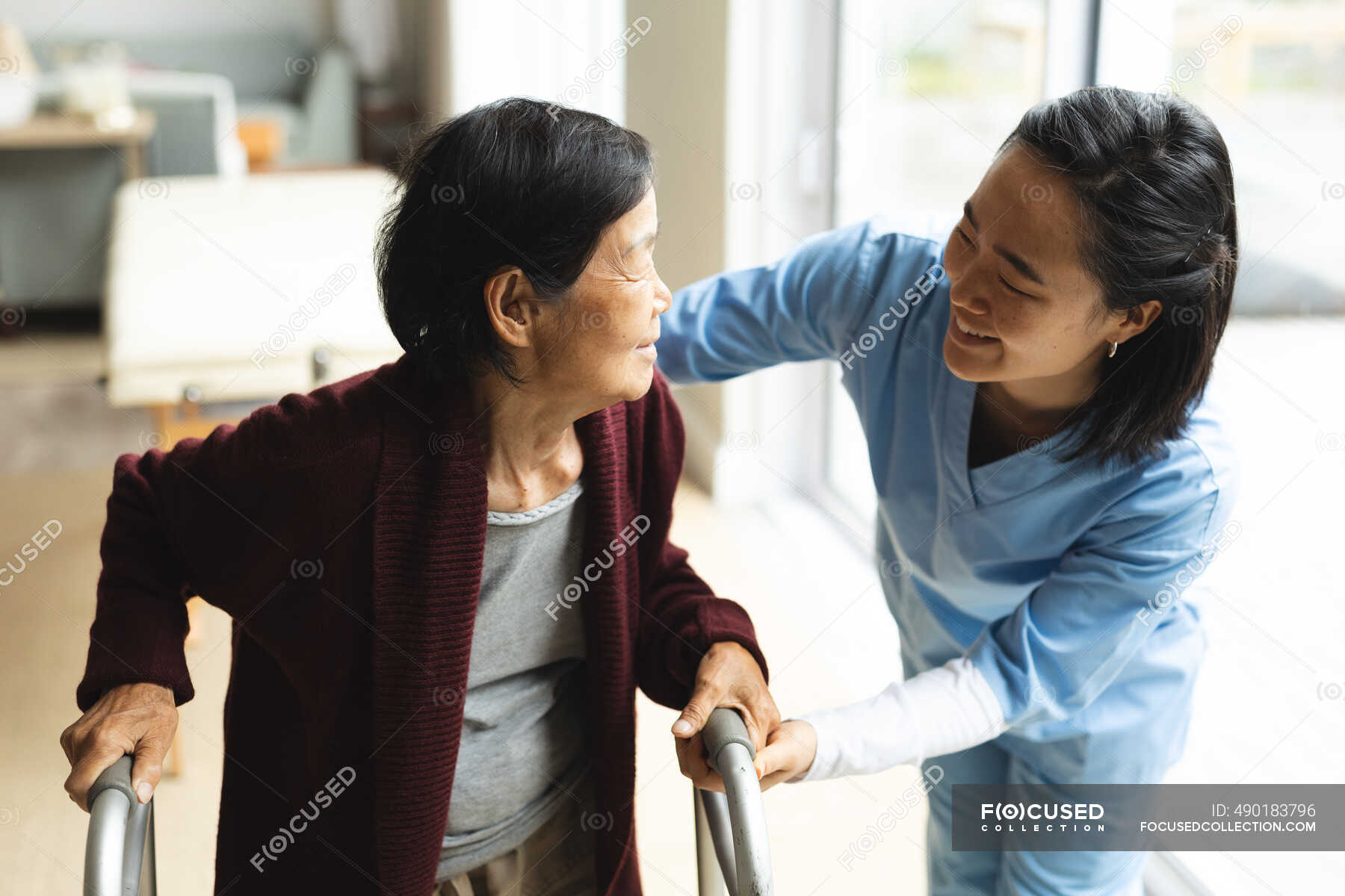 Asian Female Physiotherapist Treating Senior Female Patient At Her Home Healthcare And Medical 2080