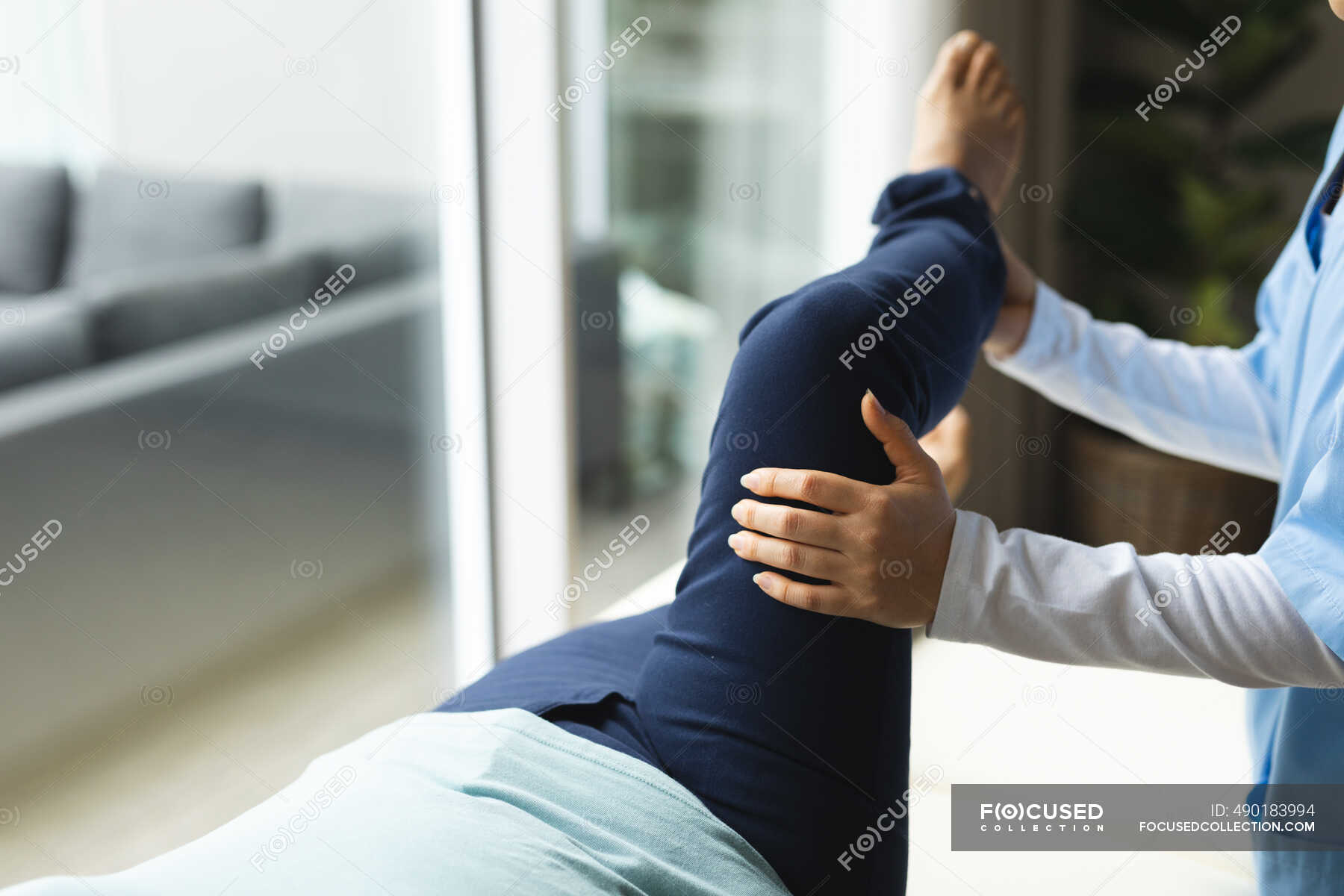 Female Physiotherapist Treating Female Patient At Her Home Healthcare And Medical Physiotherapy 5740