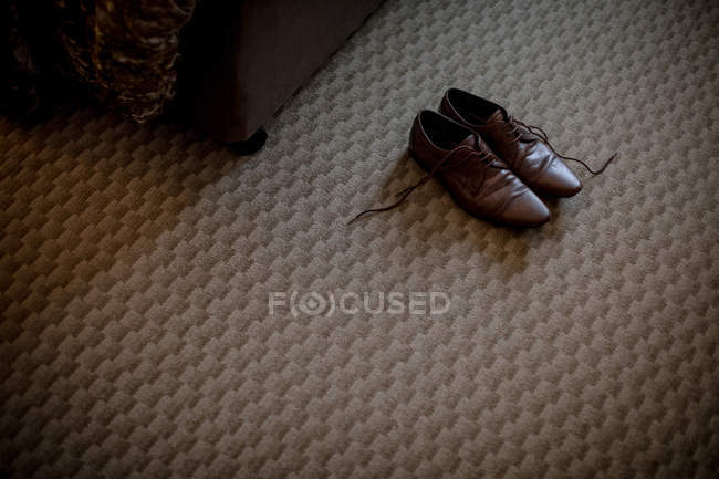 Par de zapatos marrones en habitación de hotel - foto de stock