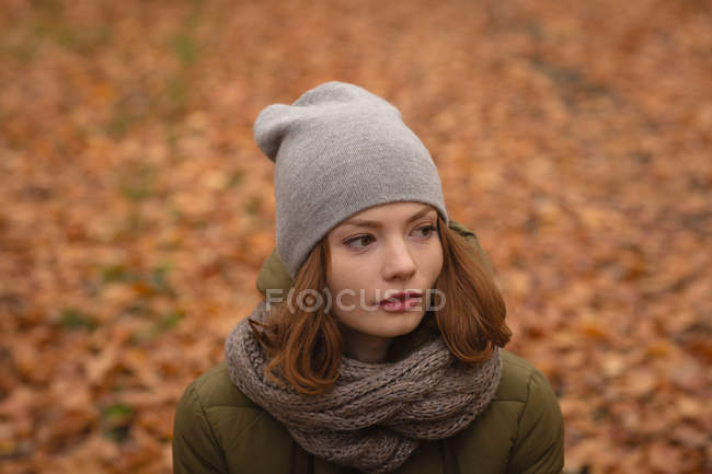 Thoughtful woman standing in the park — Stock Photo