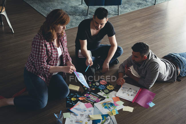 Business colleagues discussing over documents in office — Stock Photo