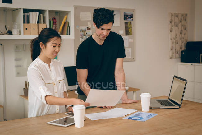 Business executives discussing over document in office — Stock Photo